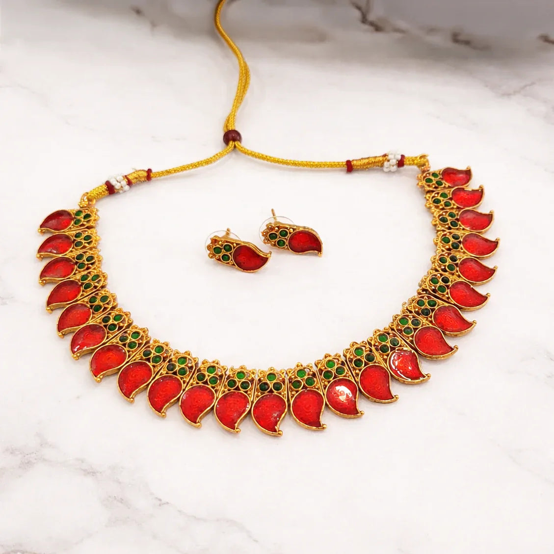 Jewelry set with necklace and earrings on a marble surface