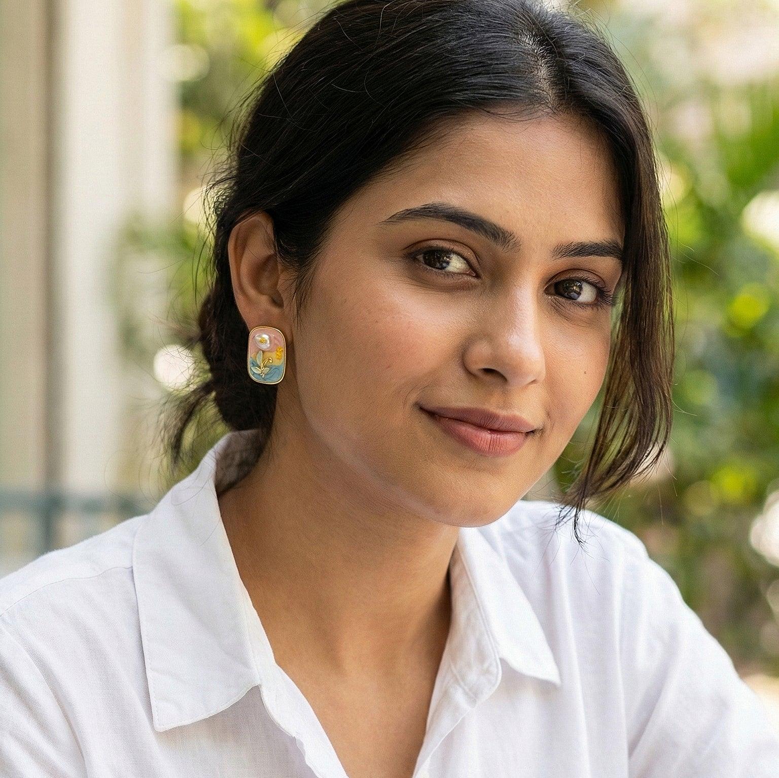 Woman wearing a white shirt with a blurred green background