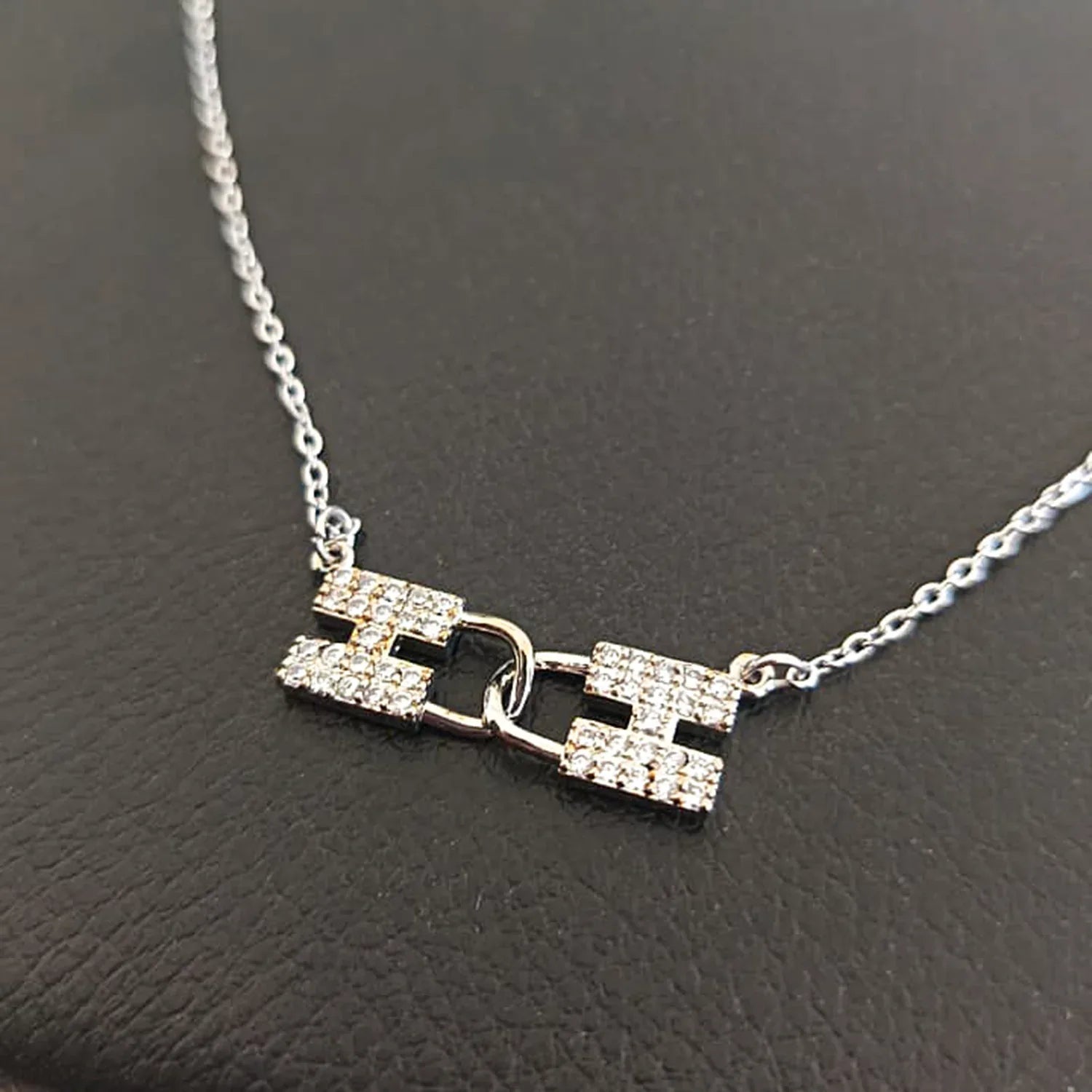 Silver necklace with a unique pendant on a dark background