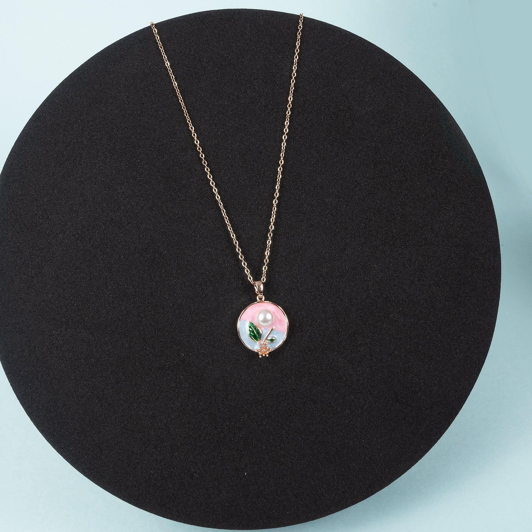 Necklace with a round pendant on a black stand against a light blue background