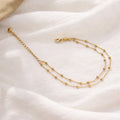 Gold bracelet on a soft white fabric background