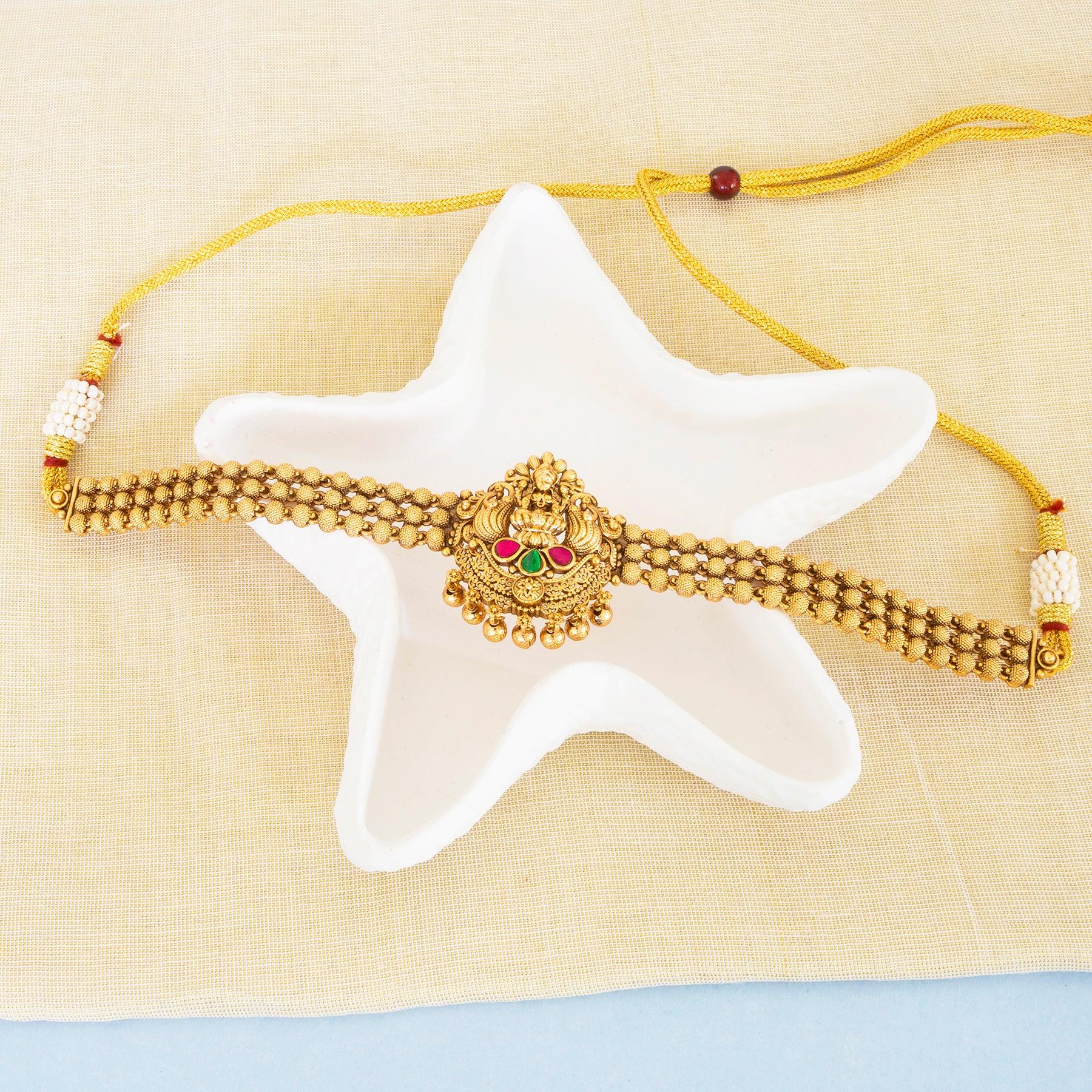 Gold bracelet with a starfish on a beige background