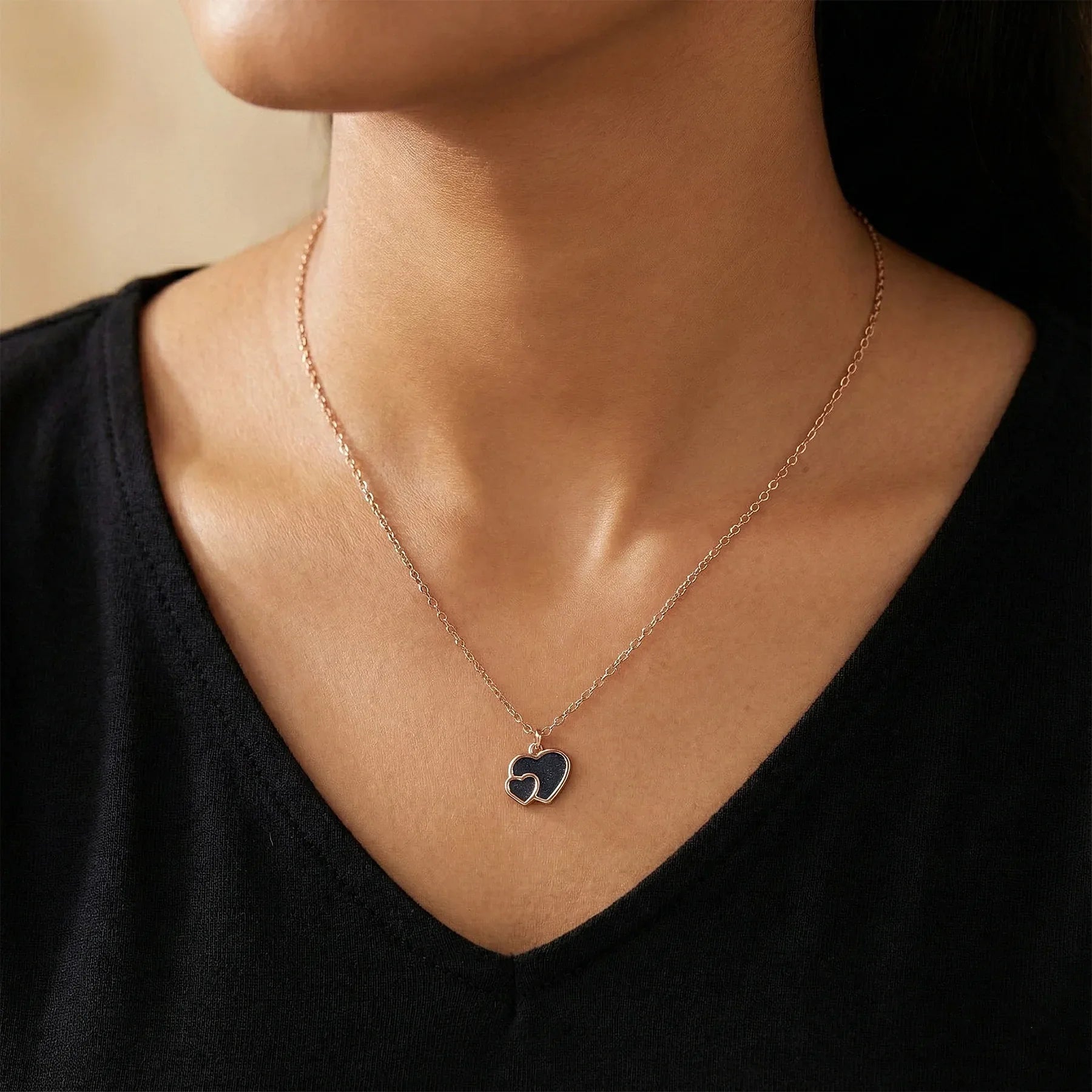 Necklace with a heart-shaped pendant worn by a person