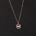 Rose gold necklace with a butterfly pendant on a black background