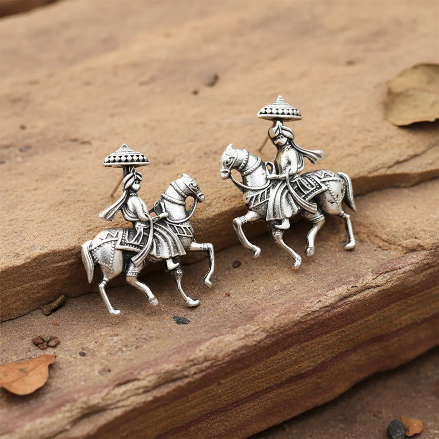 Silver equestrian figurines on a wooden surface
