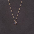 Butterfly pendant necklace on a dark gray background