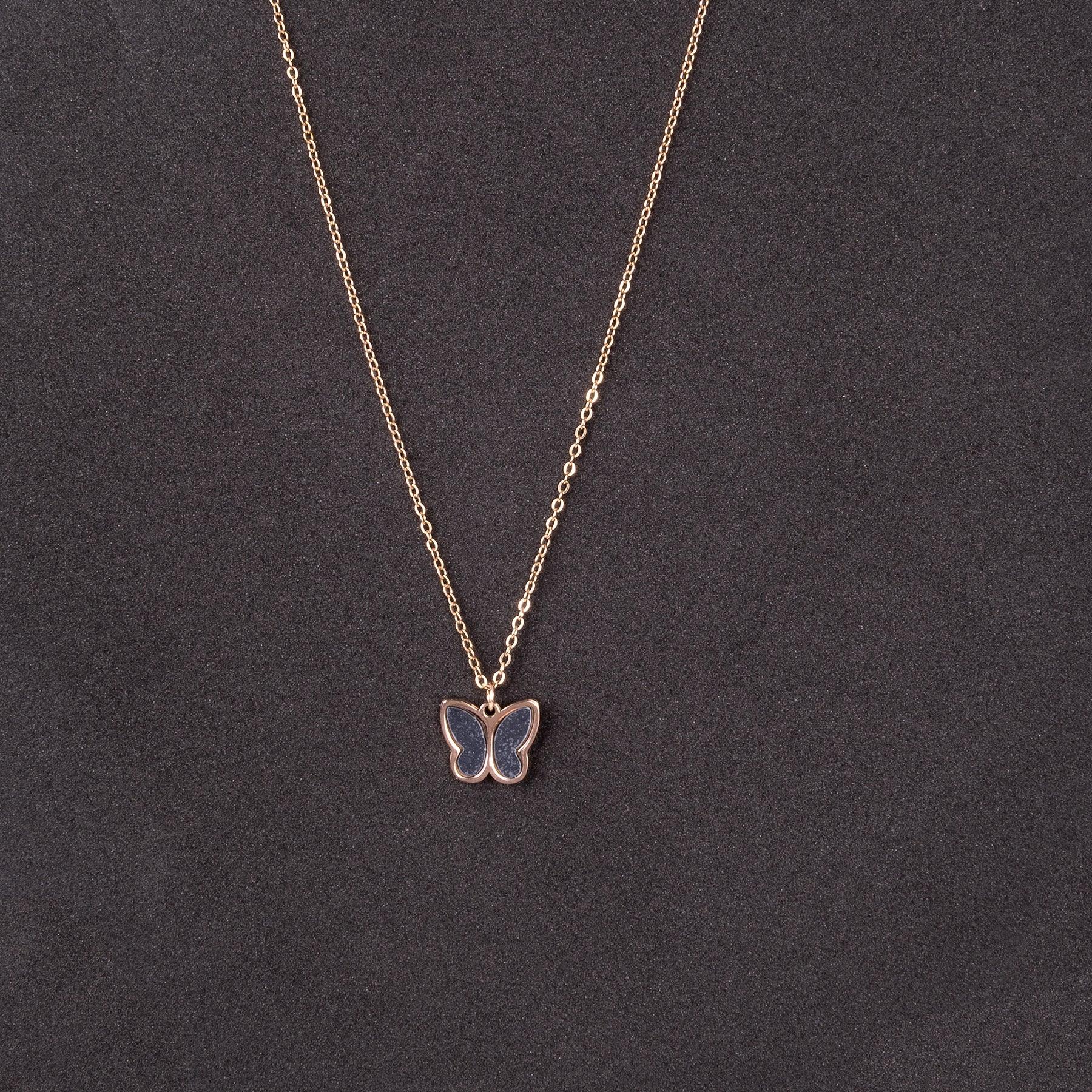 Butterfly pendant necklace on a dark gray background