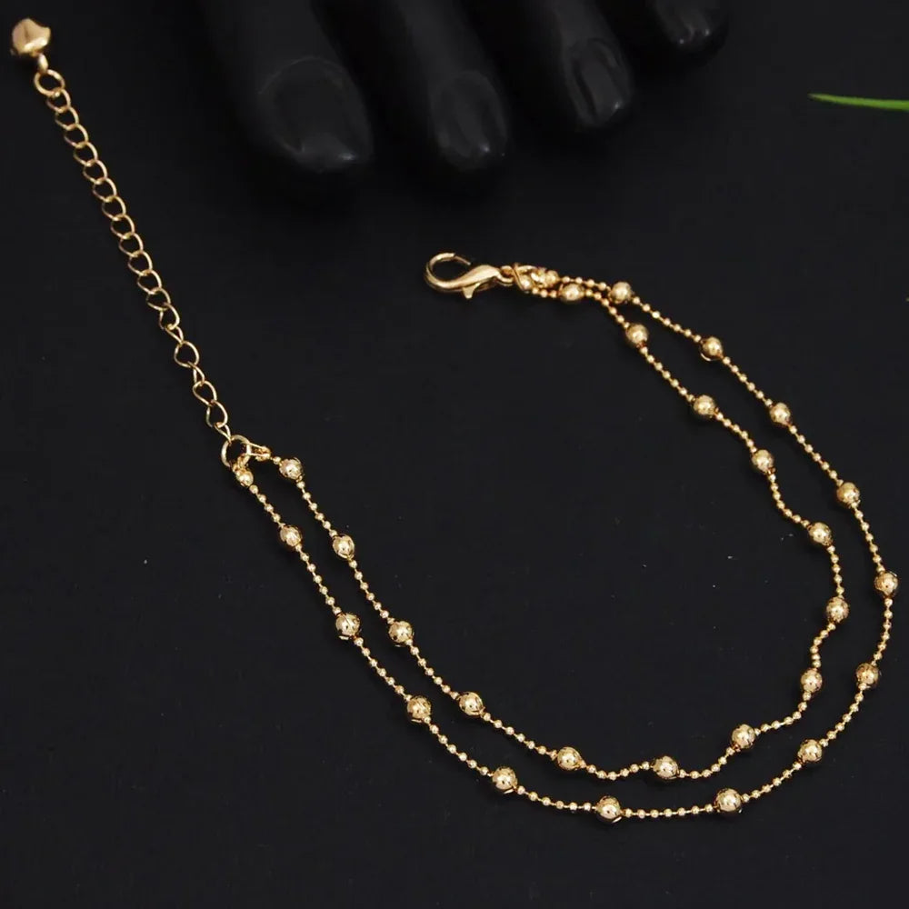 Gold chain necklace on a black background
