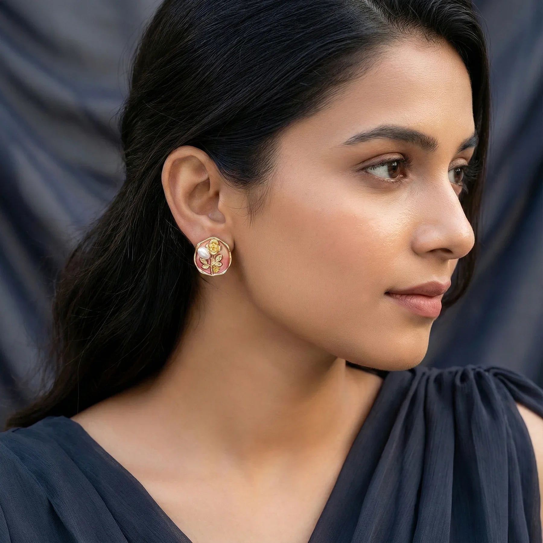 Woman wearing floral earrings with a blurred background