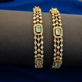 Gold and diamond bracelet on a dark surface with a blue background