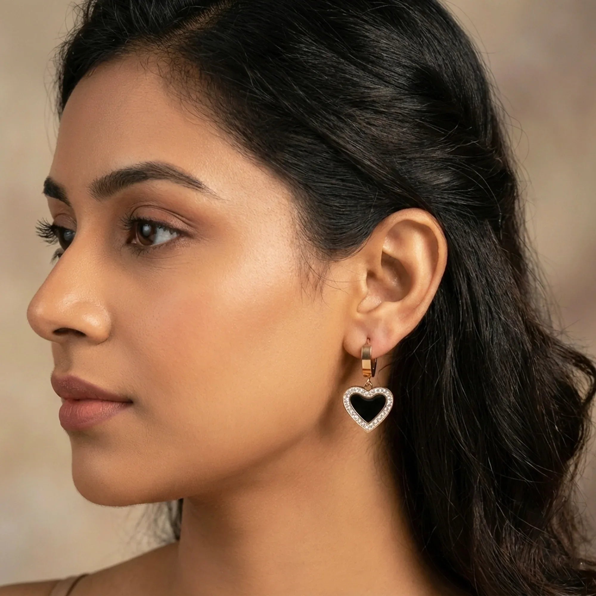 Close-up of a woman wearing a heart-shaped earring with a blurred background