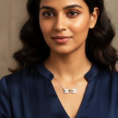 Woman wearing a necklace with a neutral background