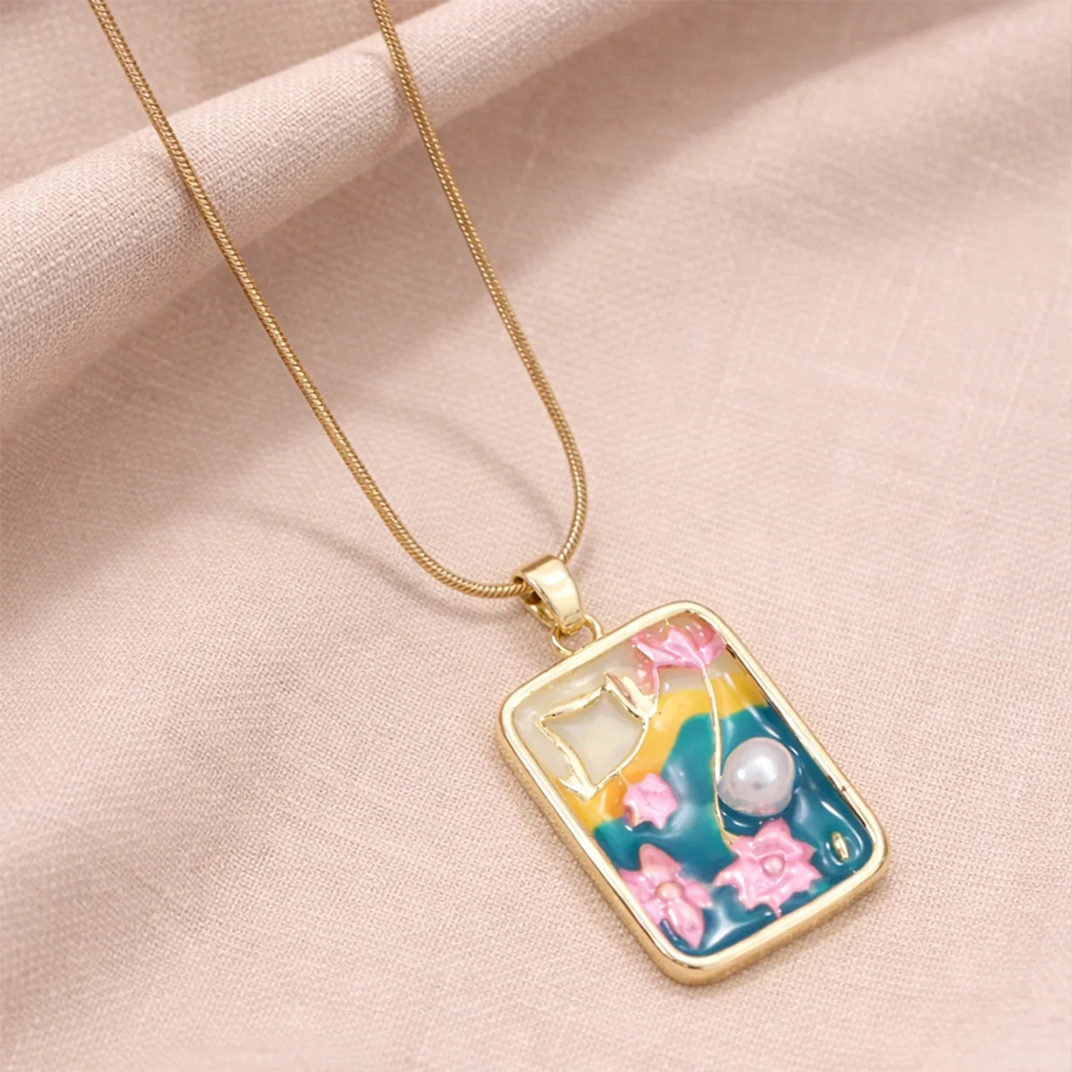 Necklace with a colorful pendant on a beige fabric background