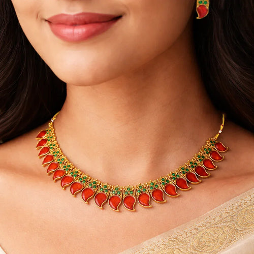 Gold necklace with red stones worn by a model