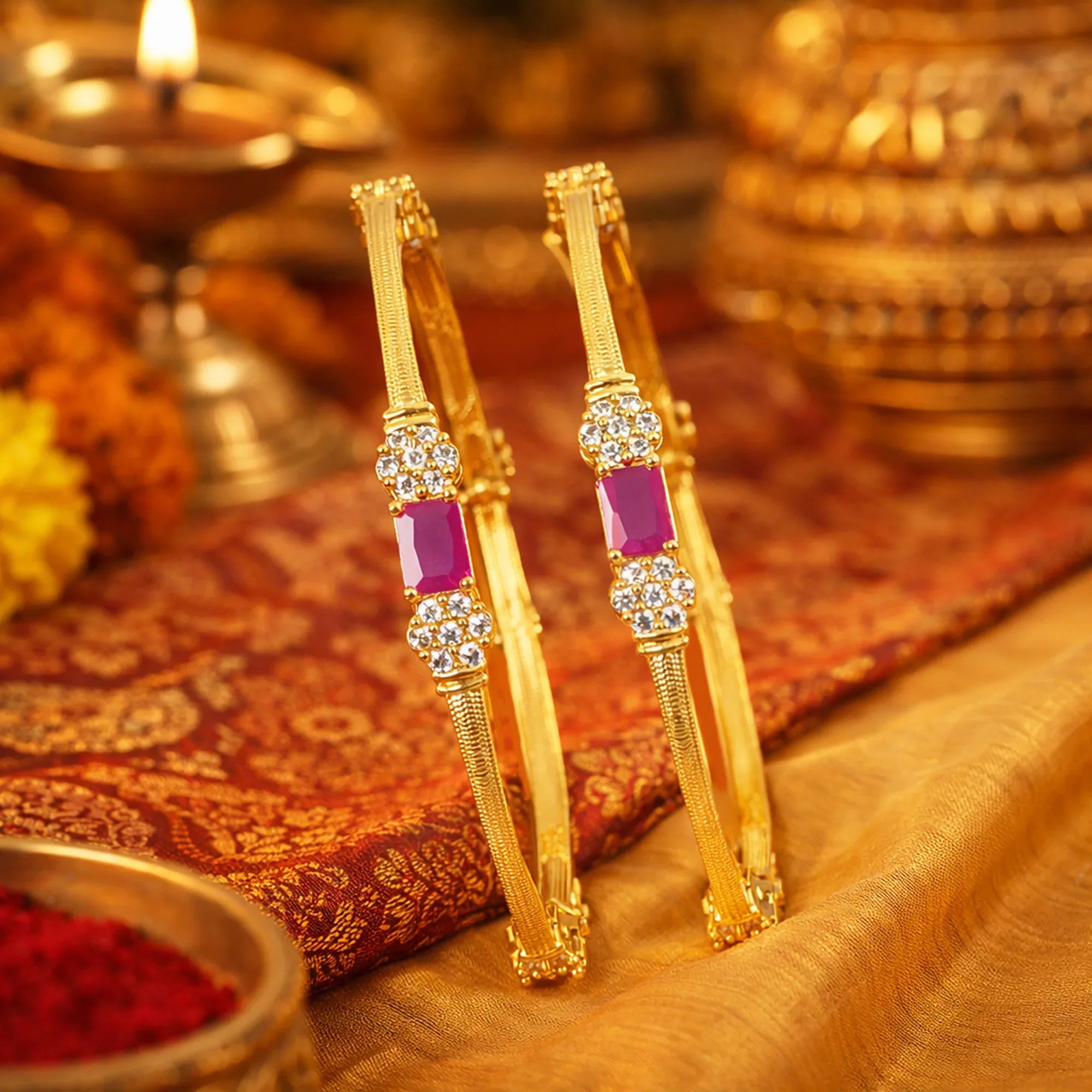 Gold bangles with purple stones on a decorative background