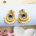 Gold earrings with blue center on a white background