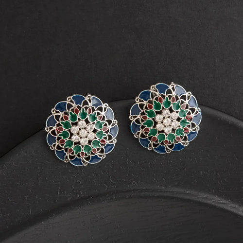 Pair of decorative earrings with green, red, and blue colors on a black background