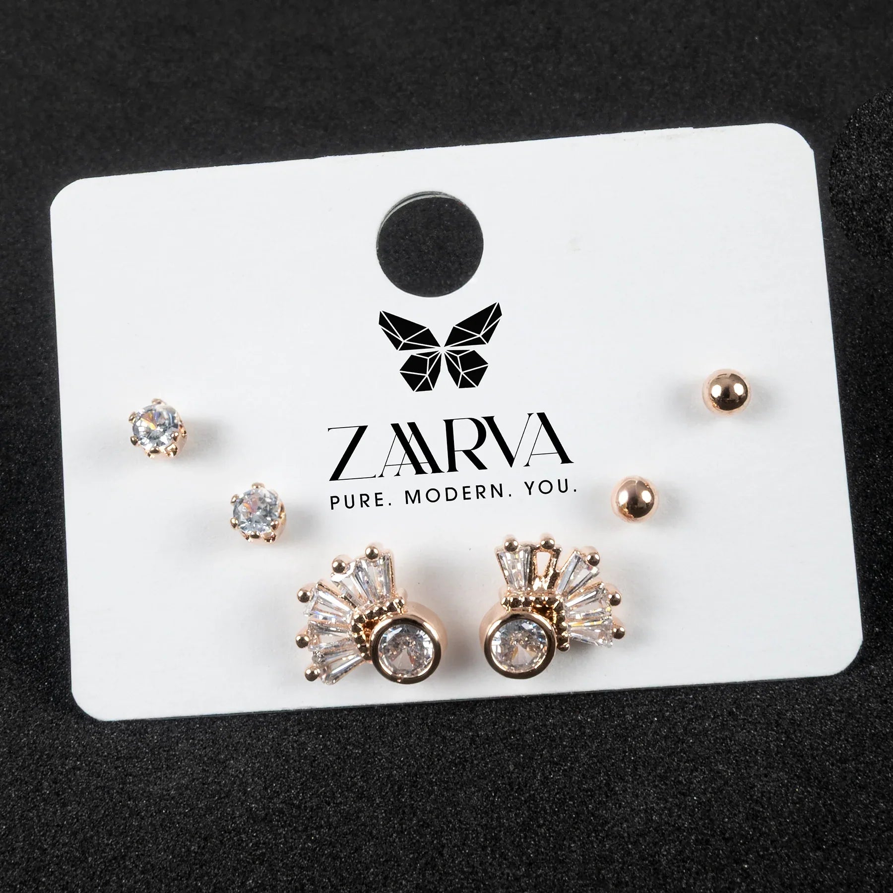 Set of earrings on a ZARVA branded card with a black background