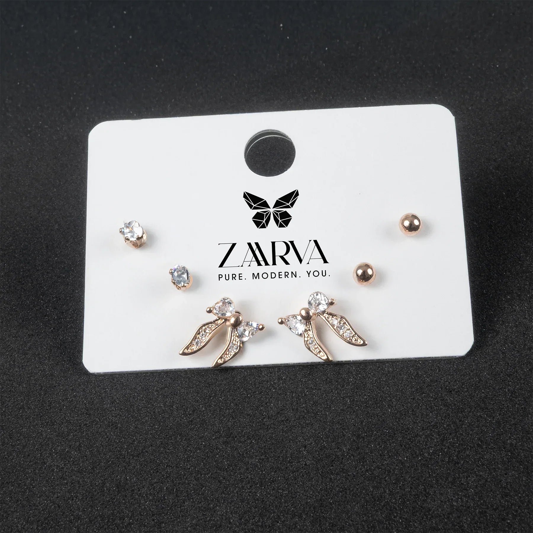 Set of earrings on a ZARVA branded card against a black background