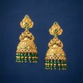 Gold and green beaded earrings on a blue background