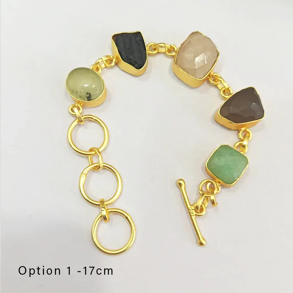 Gold bracelet with multicolored stones on a white background