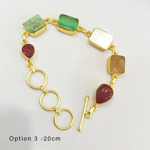 Gold bracelet with colorful gemstones on a white background
