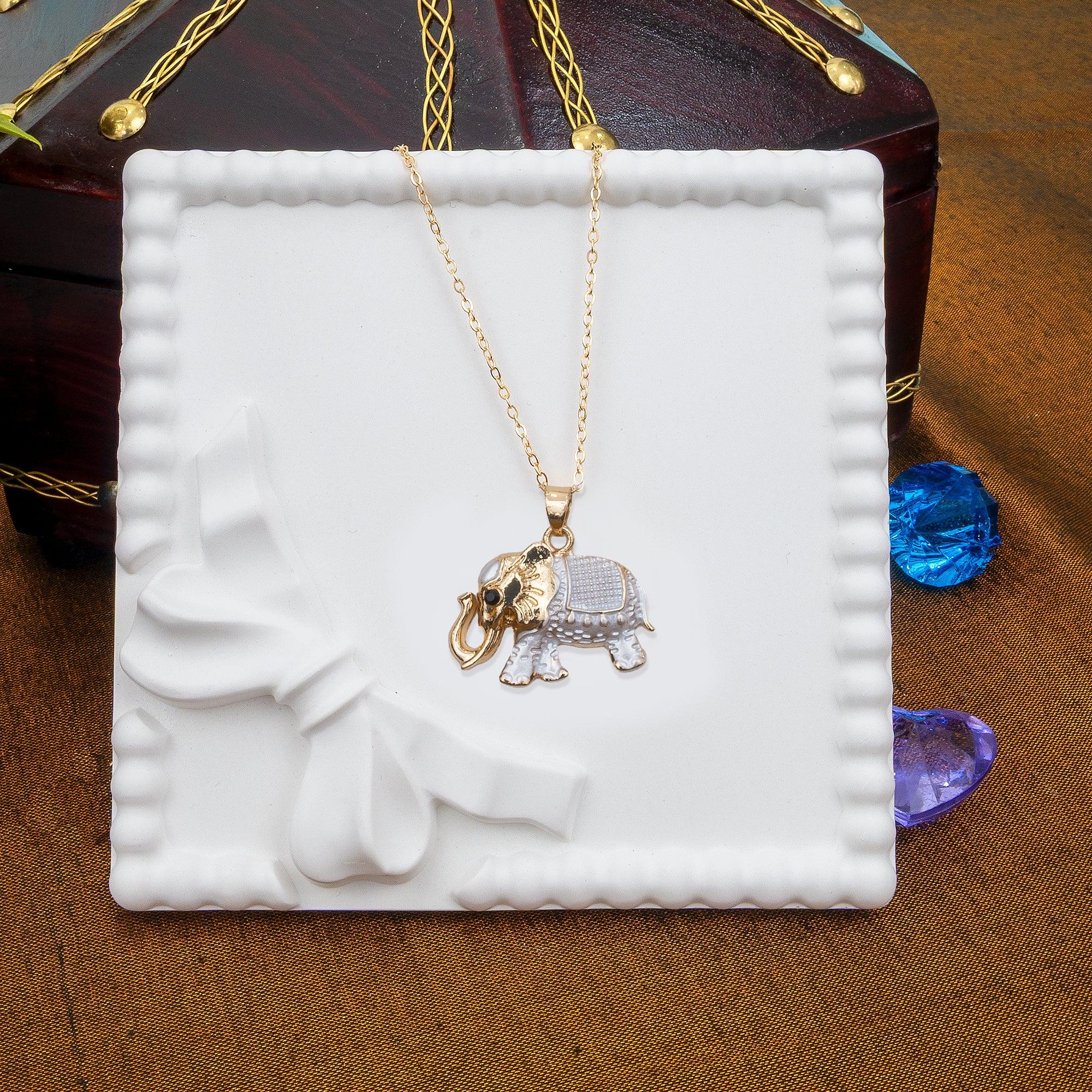 Gold necklace with elephant pendant on a white jewelry box