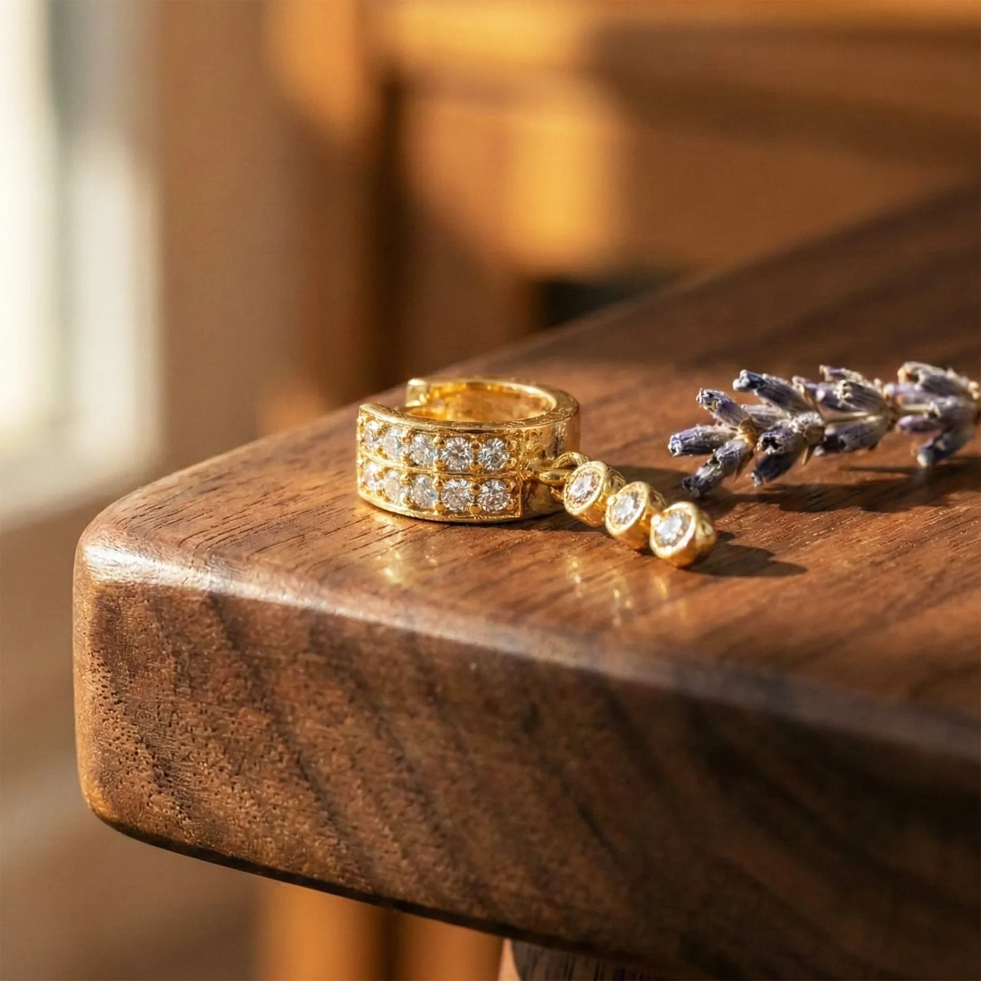 Gold ring and bracelet on a wooden surface with a blurred background