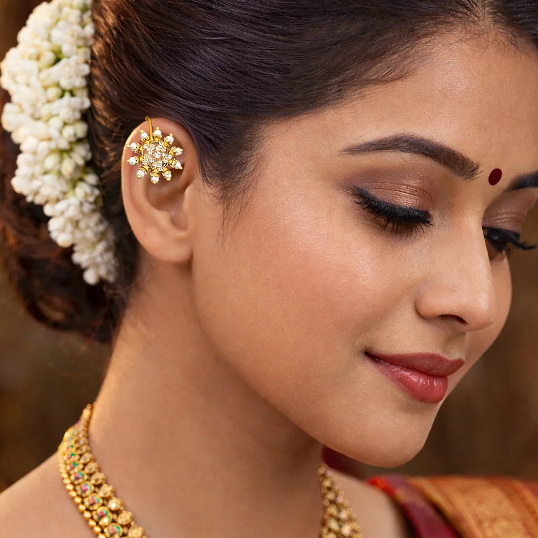 Close-up of a woman wearing traditional jewelry with a blurred background